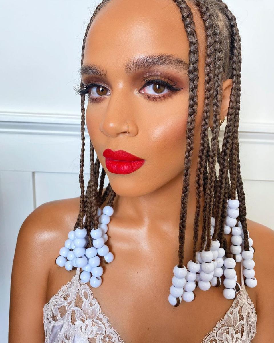 Is there anything more timeless than beaded <a href="https://www.glamour.com/gallery/fulani-braids-hairstyle-ideas?mbid=synd_yahoo_rss" rel="nofollow noopener" target="_blank" data-ylk="slk:Fulani braids;elm:context_link;itc:0;sec:content-canvas" class="link ">Fulani braids</a> with a crimson red lipstick? Don't think so. Go classic with beads in the same neutral color palette or go all out with a mix of different colors and textures.