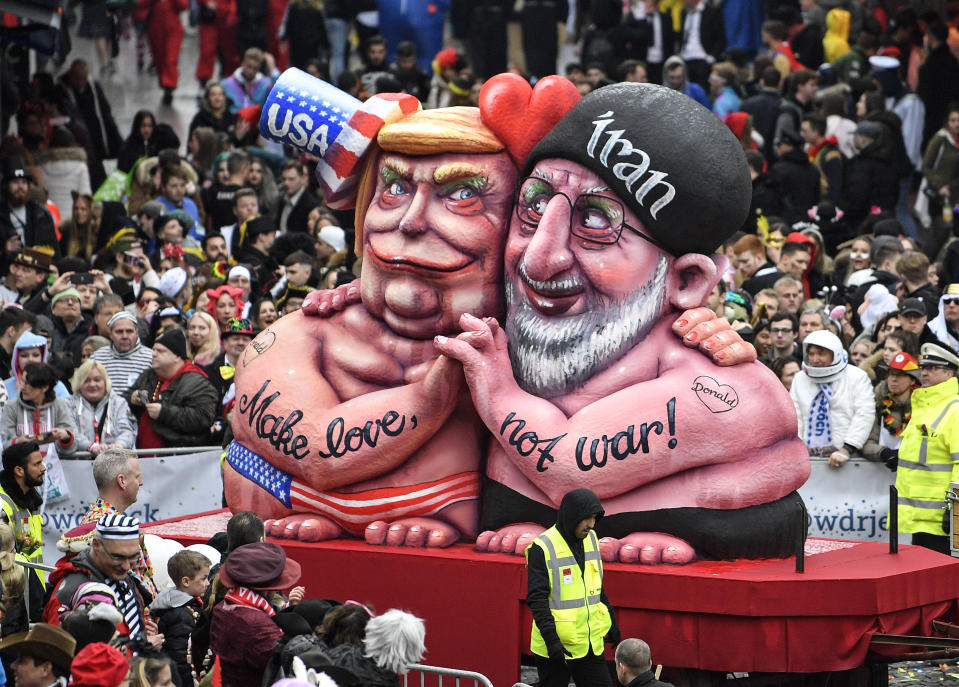 A carnival float depicts US President Donald Trump holding hands with Iran's President Hassan Rohani during the traditional carnival parade in Duesseldorf, Germany, on Monday, Feb. 24, 2020. The foolish street spectacles in the carnival centers of Duesseldorf, Mainz and Cologne, watched by hundreds of thousands of people, are the highlights in Germany's carnival season on Rosemonday. (AP Photo/Martin Meissner)