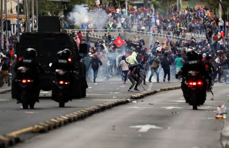 Demonstrators clash with police officers during protests after Ecuador's President Lenin Moreno's government ended four-decade-old fuel subsidies in Quito