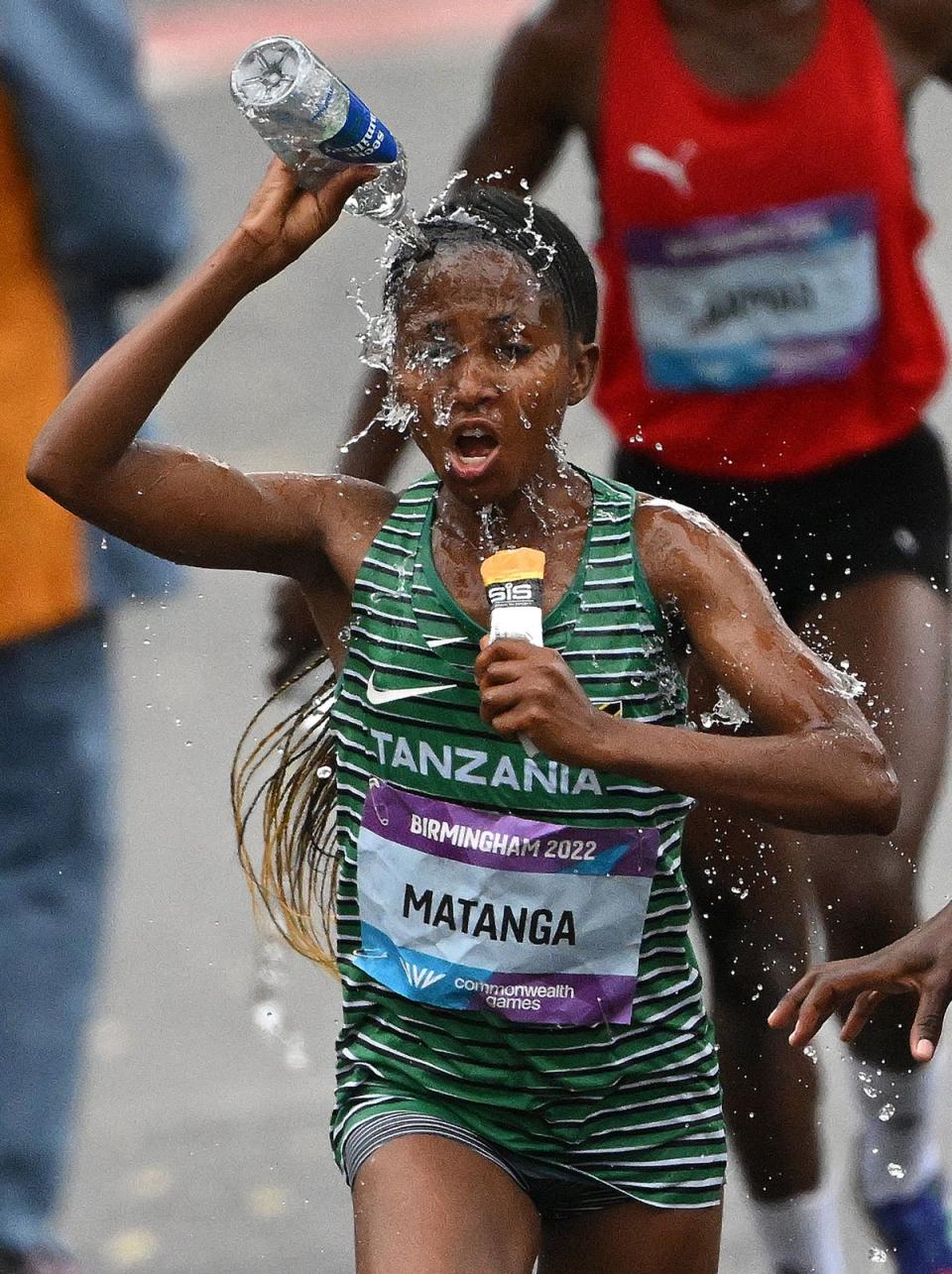 Tanzania’s Failuna Matanga douses herself in water during the Commonwealth Games Marathon (AFP via Getty)