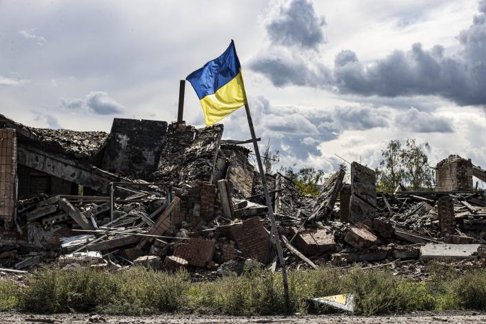 A Ukrainian flag waves in the village of Dolyna in Donetsk Oblast, Ukraine after the withdrawal of Russian troops on September 24, 2022.