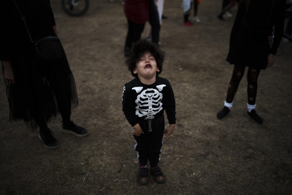 A little boy cries at the West Side Hallo Fest, a Halloween festival in Bucharest, Romania, Friday, Oct. 27, 2023. Tens of thousands streamed last weekend to Bucharest's Angels' Island peninsula for what was the biggest Halloween festival in the Eastern European nation since the fall of Communism. (AP Photo/Vadim Ghirda)