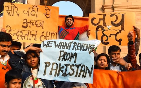 Indian demonstrators shout slogans against Pakistan during a protest at India Gate in New Delhi on Sunday  - Credit: AFP