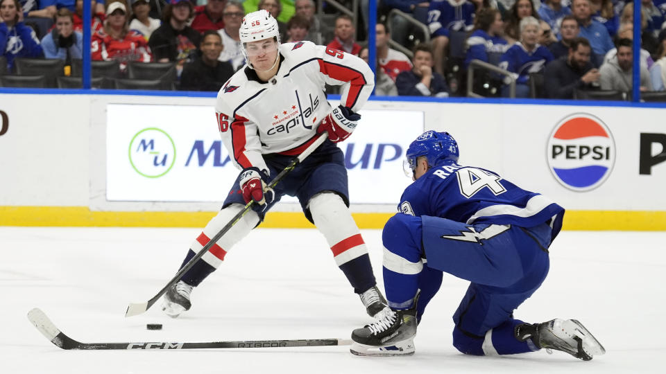 Washington Capitals right wing Nicolas Aube-Kubel (96) tries to work around Tampa Bay Lightning defenseman Darren Raddysh (43) during the first period of an NHL hockey game Thursday, Feb. 22, 2024, in Tampa, Fla. (AP Photo/Chris O'Meara)