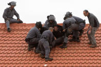 <p>Israeli police officers remove settlers from a roof top in the West Bank settlement of Ofra, Wednesday, March 1, 2017. Israeli forces are demolishing nine homes in the heart of the West Bank settlement of Ofra after the Supreme Court ruled they were built on private Palestinian land. (AP Photo/Sebastian Scheiner) </p>