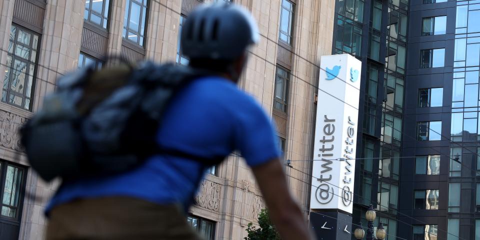 A cyclist walks past Twitter's headquarters in San Francisco