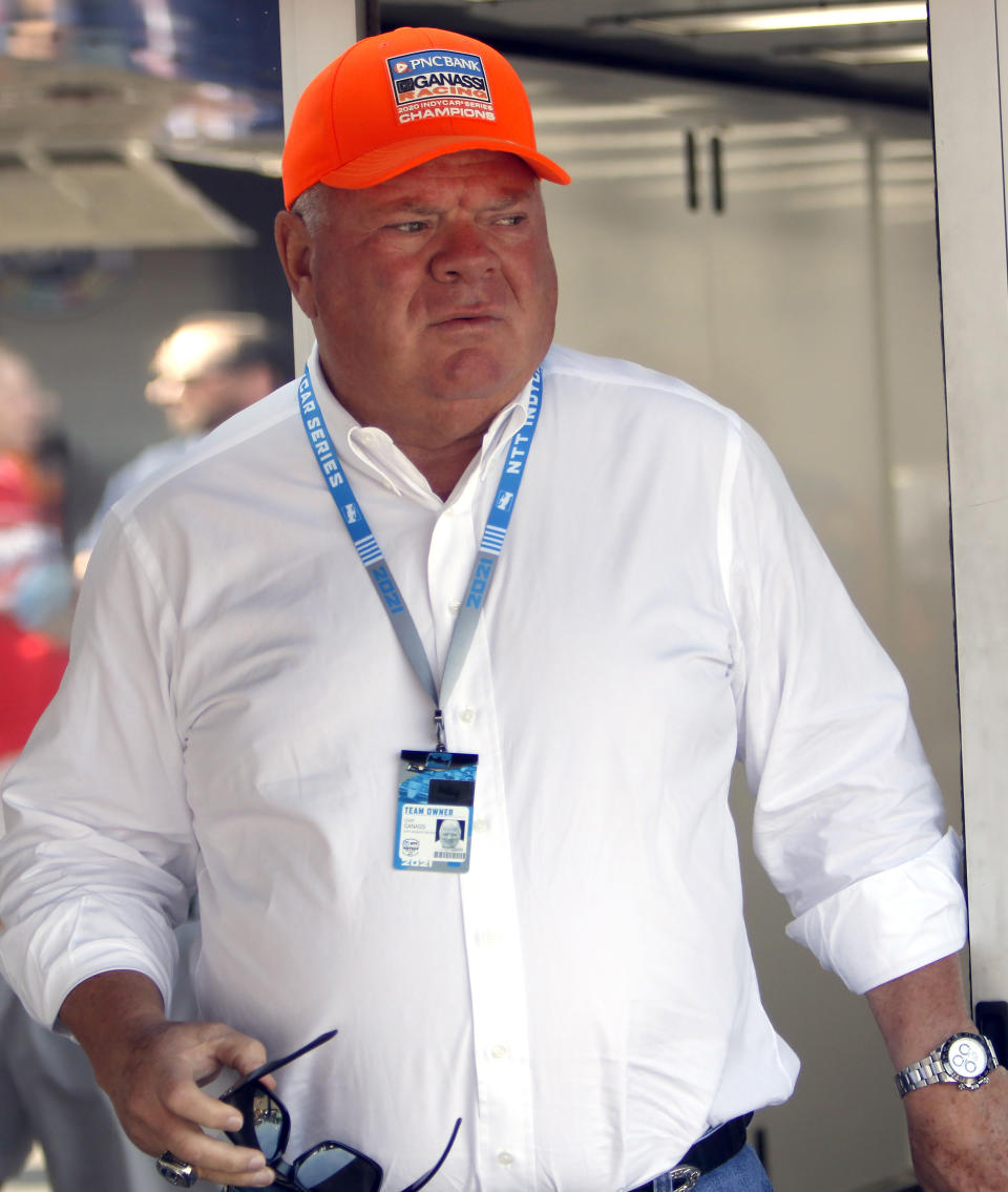 FILE - Car owner Chip Ganassi is seen in the paddock before an IndyCar race at Mid-Ohio Sports Car Course in Lexington, Ohio, Sunday, July 4, 2021. There is no love lost between rival team owners Chip Ganassi and Zak Brown, and the two now find themselves entangled over the reigning IndyCar champion. Ganassi says he picked up the option on Alex Palou for 2023, but McLaren Racing says it has signed the Spaniard for next year. (AP Photo/Tom E. Puskar, File)