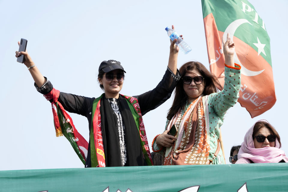 Supporters of Pakistan's main opposition 'Tehreek-e-Insaf party' attend at a rally in Lahore, Pakistan, Saturday, Oct. 29 2022. Khan along with thousands of his supporters in a large convoy of buses and cars Friday began his much-awaited march on the capital Islamabad from the eastern city of Lahore to demand the holding of snap elections, a sign of deepening political turmoil. (AP Photo/K.M. Chaudary)