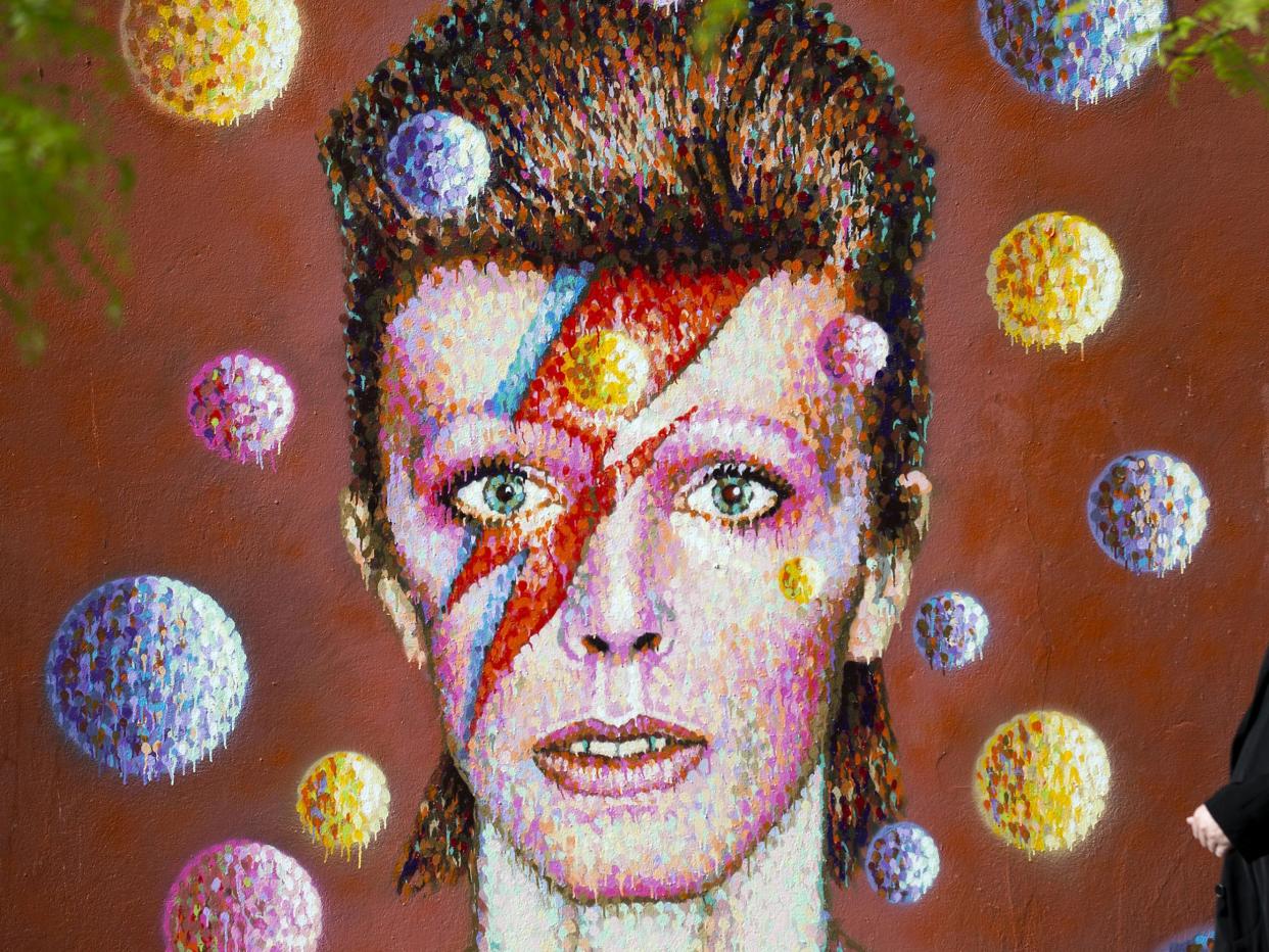 <p>The cover of Bowie's Aladdin Sane album, replicated here in a mural, is one of the most enduring images of the artist</p> (AFP/Getty)