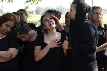 Relatives of Alawite soldier Ali Khaddaaro, who was killed during clashes between Lebanese Army soldiers and Islamist militants in Arsal, mourn during his funeral in Talhmera village, Akkar August 5, 2014. REUTERS/Stringer