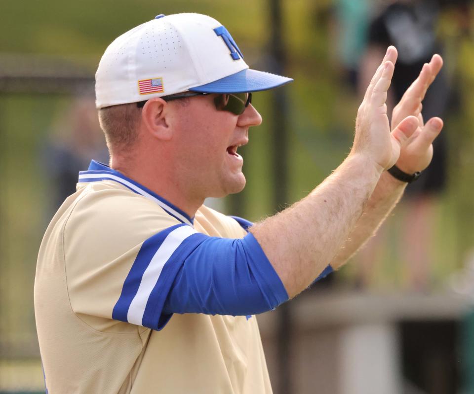 Norwell High School varsity baseball coach Barrett Jacobs, in his first season after taking over the reins from his father, Tom, gestures during a game versus Abington on Wednesday, May 24, 2023.