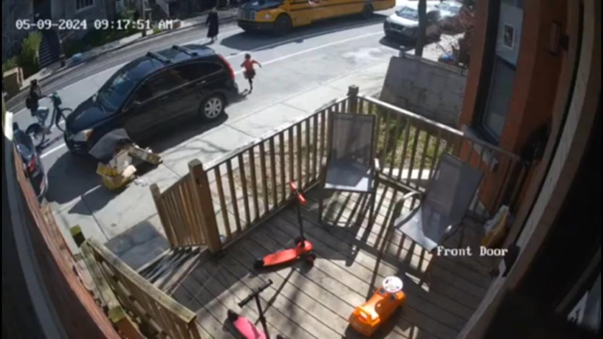 This screengrab from a video shared on social media by Mayer Feig shows the moment the young girl crosses the street as the cyclist is approaching.  (Mayer Feig/X - image credit)