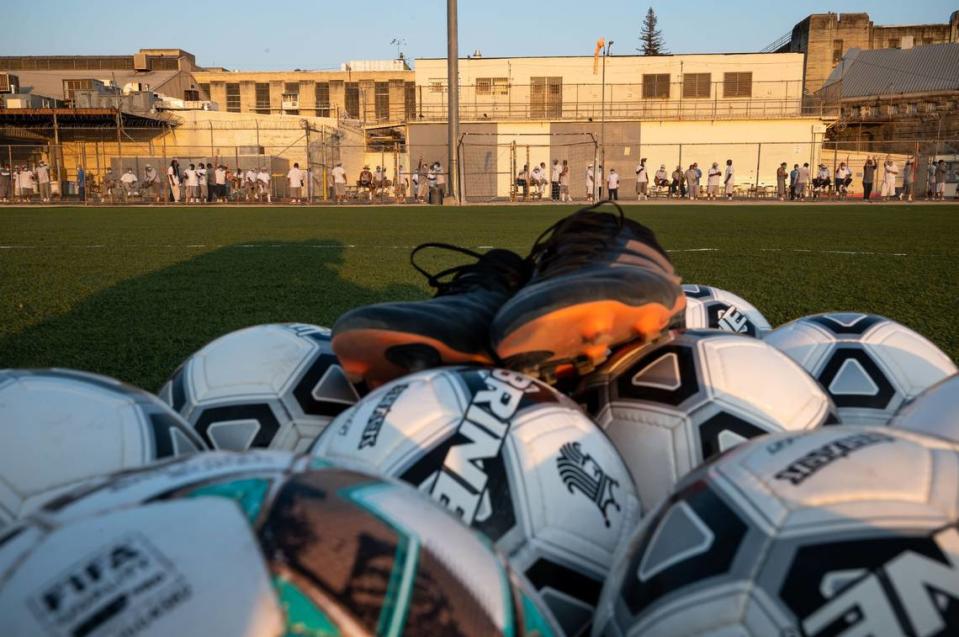 Sacramento Republic FC soccer balls and gear are gathered at the center of the field in the yard at Folsom State Prison on Aug. 24, 2021, after the team’s full training session. The visit to the historic California Department of Corrections and Rehabilitation prison was the team’s first since their regularly scheduled monthly visits — featuring pickup games with prisoners and Republic players and staff — were halted in March of 2020 due to the COVID-19 pandemic.