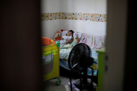 Daniel Vieira, who is two years old, and was born with microcephaly, sleeps at his home in Olinda, Brazil, August 7, 2018. During her pregnancy, Daniel's mother Jackeline Vieira de Souza learned that her son had microcephaly. "When he was born, I fell in love with him because I knew he would be a good thing in my life, even with the difficulties I would have to face." Daniel's father separated from Jackeline shortly after learning that his son had microcephaly. He pays a small amount of family support every month, in addition to a monthly check that Jackeline gets from the government. It takes several hours to travel by bus between their home in Olinda and Recife, where Daniel goes for treatments. Lately, those trips are somewhat less frequent, and Jackeline believes Daniel's health is more stable. She has no illusions that her son will ever walk, eat on his own or live a normal life. Yet in many ways she is grateful for her "miracle" baby, who she says makes her feel "happy and more accomplished." REUTERS/Ueslei Marcelino