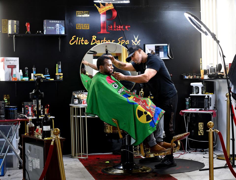 Prince Virtuez styles Ash Mbua of Worcester in his Main South shop, Palace Elite Barber Spa.