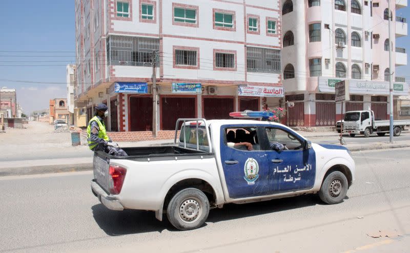 Police vehicle patrols a street during curfew after state's first case of COVID-19 was announced, in al-Sheher