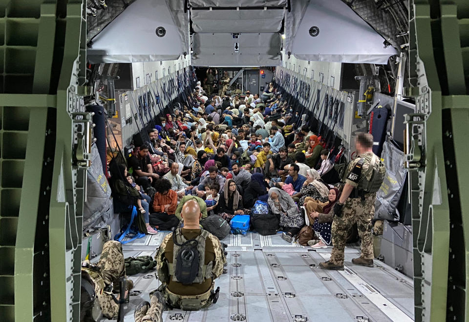 TASHKENT, UZBEKISTAN - AUGUST 22: In this handout image provided by the Bundeswehr,  evacuees from Kabul sit inside a military aircraft as they arrive at Tashkent Airport on August 22, 2021 in Tashkent, Uzbekistan. German Chancellor Merkel said Germany must urgently evacuate up to 10,000 people from Afghanistan for which it is responsible. (Photo by Handout/Bundeswehr via Getty Images)