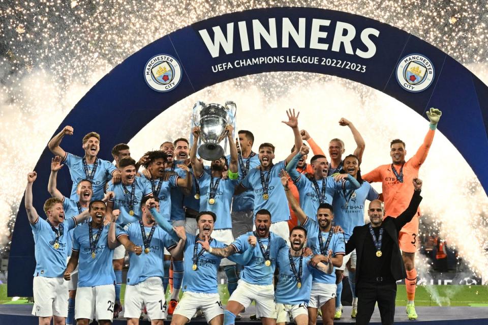 Manchester City celebrate with the trophy (AFP/Getty)