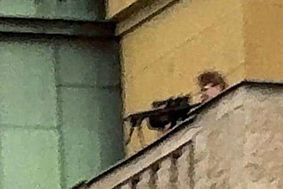 Kozak pointing a rifle at the square below (Supplied)