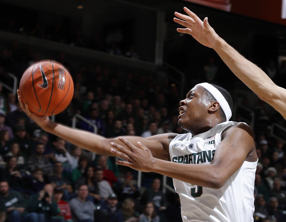 FILE - In this Dec. 16, 2018, file photo, Michigan State's Cassius Winston puts up a layup against Green Bay during the first half of an NCAA college basketball game, in East Lansing, Mich. Winston was named the Big Ten Conference Player of the Year, Tuesday, March 2, 2019. (AP Photo/Al Goldis, File)