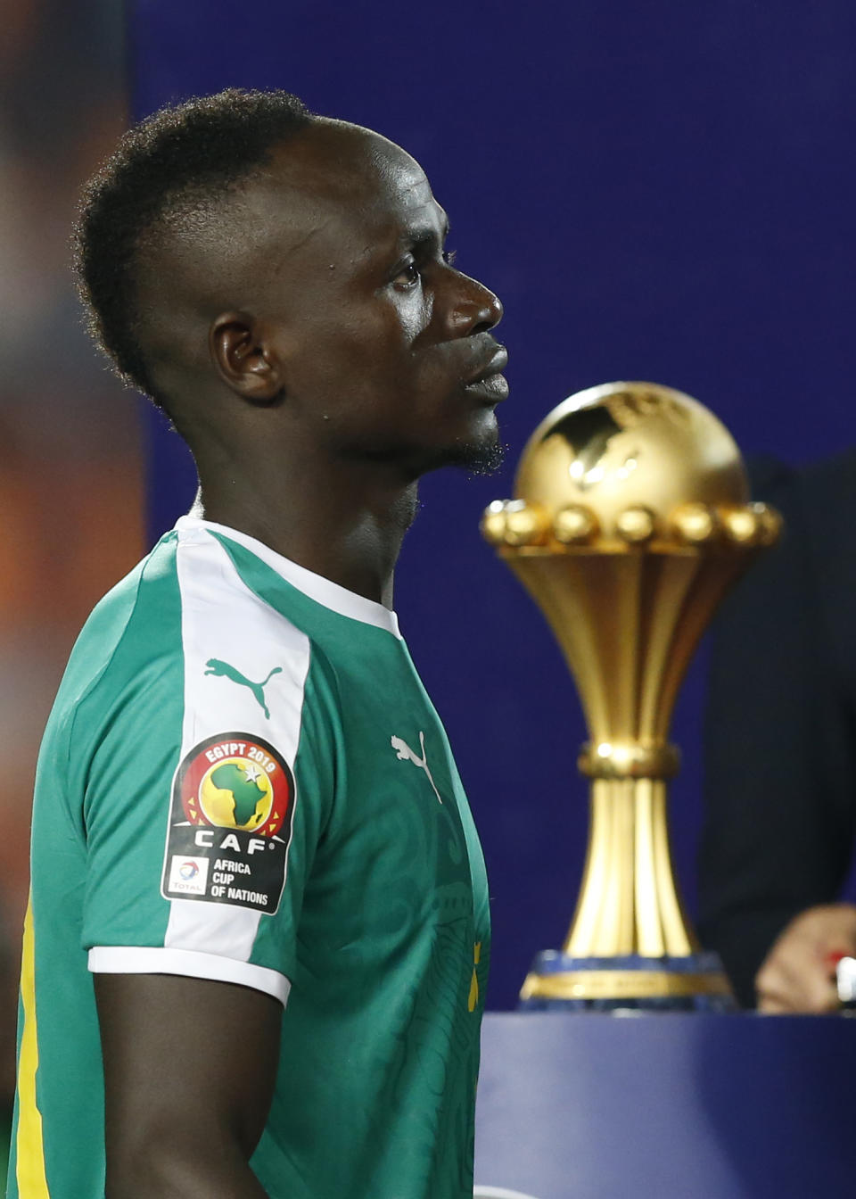 Senegal's Sadio Mane walks past the Cup after the African Cup of Nations final soccer match between Algeria and Senegal in Cairo International stadium in Cairo, Egypt, Friday, July 19, 2019. Algeria won 1-0. (AP Photo/Ariel Schalit)