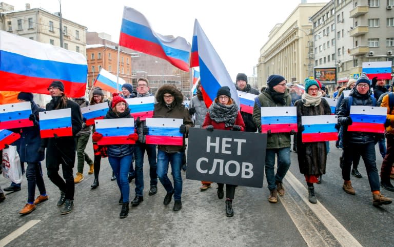 Thousands of Muscovites marched in memory of Kremlin critic Boris Nemtsov who was gunned down three years ago, a rare sanctioned opposition gathering ahead of next month's presidential vote. The placard in Russian reads "No words"