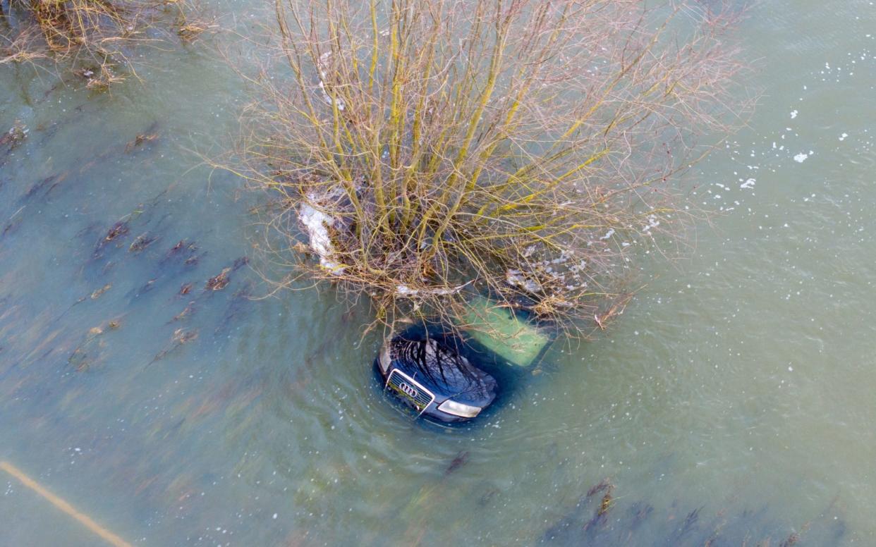 A Audi car submerged after it got caught out on Britain's lowest road, the A1101 in Welney Norfolk, ahead of strong winds hitting Britain on Thursday