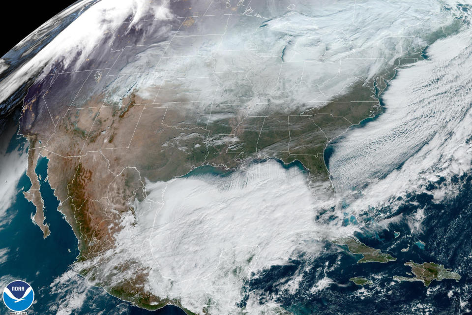 This satellite image made available by NOAA shows weather systems across North America on Saturday, Dec. 24, 2022, at 12:06 p.m. EST. A battering winter storm knocked out power to hundreds of thousands of homes and businesses across the United States on Saturday, left millions more to worry about the prospect of further outages and crippled police, fire departments and an airport in snow-blown New York state. (NOAA via AP)