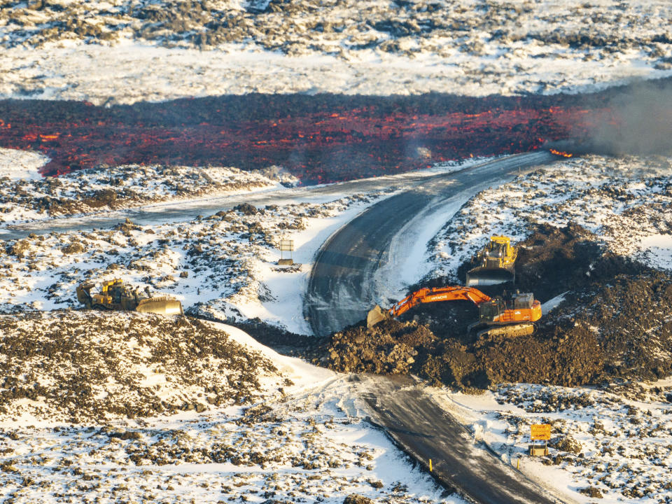 A view of lava crossing the main road to Grindavík and flowing on the road leading to the Blue Lagoon, in Grindavík, Iceland, Thursday, Feb. 8, 2024. A volcano in southwestern Iceland has erupted for the third time since December and sent jets of lava into the sky. The eruption on Thursday morning triggered the evacuation the Blue Lagoon spa which is one of the island nation’s biggest tourist attractions. (AP Photo /Marco Di Marco)