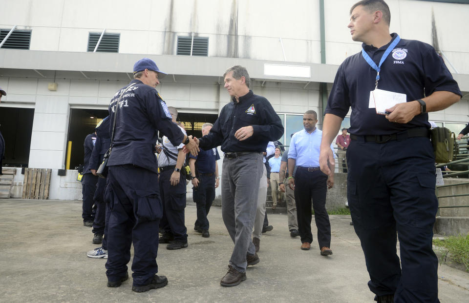 In this Sept. 12, 2018 photo, North Carolina Democratic Gov. Roy Cooper meets members of FEMA, Search and Rescue Teams and officials at the Global TransPark in Kinston, N.C., ahead of Hurricane Florence. Cooper has been praised by man, including Republicans, for his handling of the state’s immediate response to Florence.(Janet S. Carter/Daily Free Press via AP)