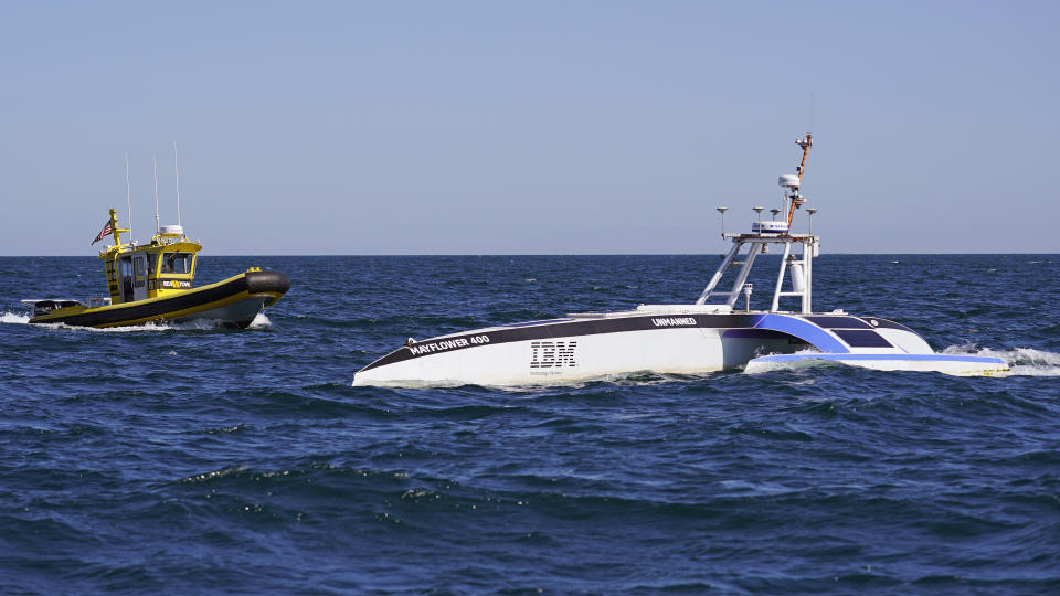 A tow boat approaches the Mayflower Autonomous Ship, Thursday, June 30, 2022, about twenty miles off the coast of Plymouth, Mass., after a crew-less journey from Plymouth, England. (AP Photo/Charles Krupa)