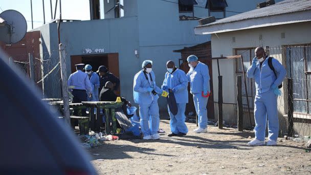 PHOTO: Forensic personnel investigate after the deaths of patrons found inside the Enyobeni Tavern, in Scenery Park, outside East London in the Eastern Cape province, South Africa, June 26, 2022. (Stringer/Reuters)