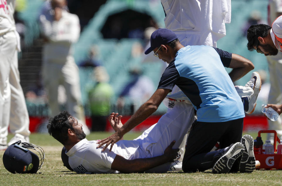 India's Hanuma Vihari receives treatment to a leg injury during play on the final day of the third cricket test between India and Australia at the Sydney Cricket Ground, Sydney, Australia, Monday, Jan. 11, 2021. (AP Photo/Rick Rycroft)