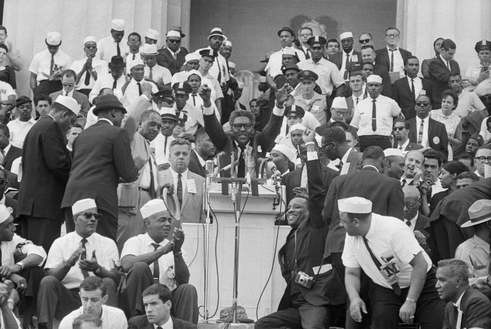 Bayard Rustin, deputy director of the March on Washington, speaks to the crowd of marchers from the Lincoln Memorial.