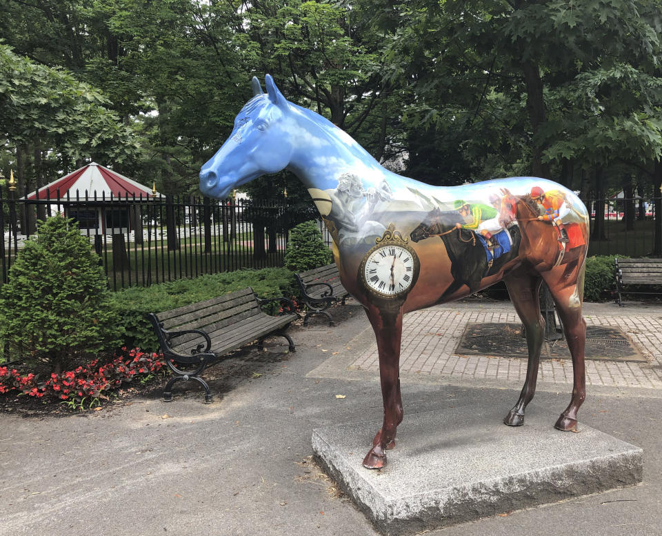 A horse sculpture stands outside the gate on the first day of horse racing at the Saratoga Race Course in Saratoga Springs, N.Y., Thursday, July 16, 2020. A Saratoga season like no other is underway, with fans barred from attending the start of the 152nd meet in track history and most likely the entire 40 days of racing. (AP Photo/John Kekis)