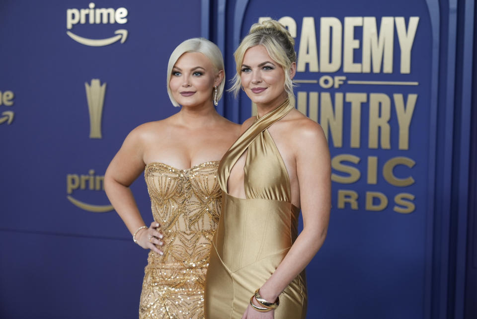 Kendra Slaubaugh, left, and Krista Slaubaugh of Tigirlily Gold arrives at the 59th annual Academy of Country Music Awards on Thursday, May 16, 2024, at the Ford Center in Frisco, Texas. (AP Photo/LM Otero)