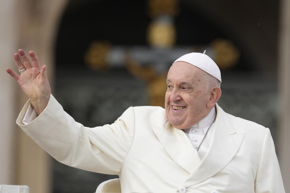 FILE - Pope Francis smiles as he waves faithful at the end of his weekly general audience in St. Peter's Square, at the Vatican, Wednesday, Nov. 22, 2023. Pope Francis cancelled his trip to Dubai for the U.N. climate conference on doctors’ orders. The announcement marked the second time the pope’s frail health had forced the cancellation of a foreign trip: He had to postpone a planned trip to Congo and South Sudan in 2022 because of knee inflammation, though he was able to make the trip earlier this year. (AP Photo/Andrew Medichini, File)