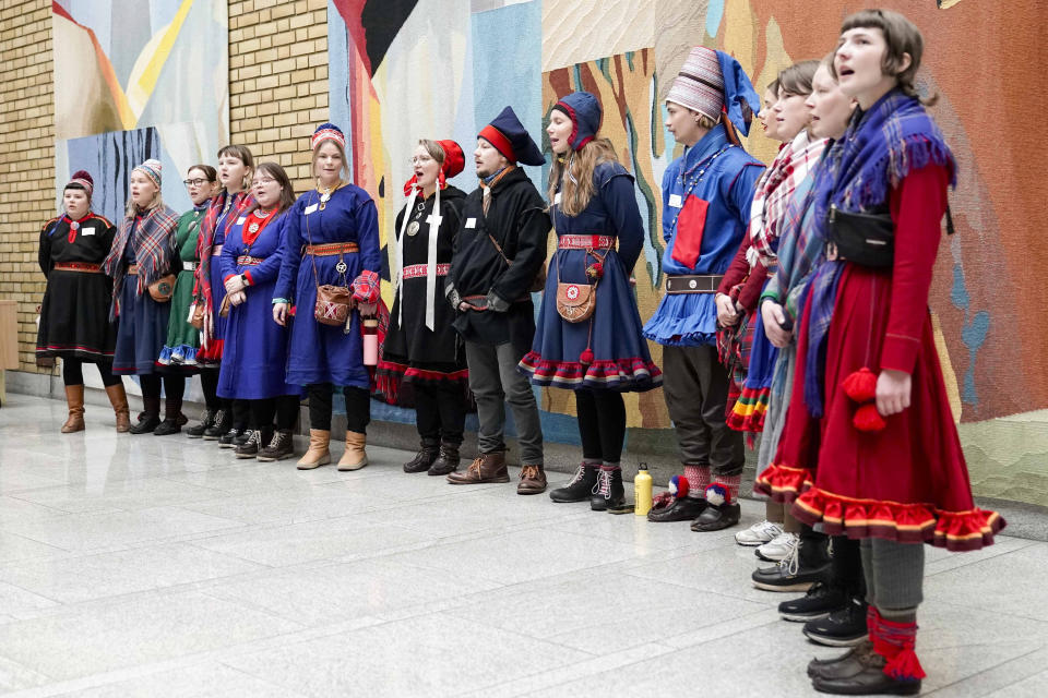 Activists wearing traditional Sami costumes chant during a demonstration in the central hall of Storting, the Norwegian parliament, in Oslo, Wednesday, Oct. 11, 2023. Dozen of activists, including Indigenous Sami, protested Wednesday saying they are fed up with Norway’s government about a wind farm they want removed in the Fosen district, about 450 kilometers (280 miles) north of Oslo, because they say it endangers the reindeer herders’ way of life. (Håkon Mosvold Larsen/NTB Scanpix via AP)