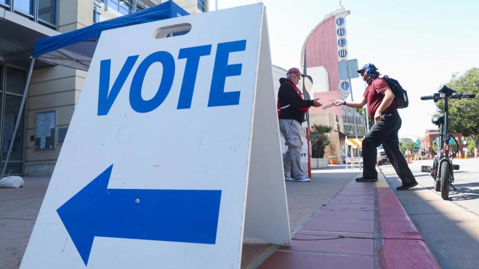 Robert Broughton rode a scooter to the San Luis Obispo County Government Center and gave his ballot to elections volunteer Larry Merkle, left, who dropped it in the curbside ballot box. Sept. 14, 2021, was Election Day in the recall race that will decide whether Gov. Gavin Newsom will remain in office or be replaced by another candidate. David Middlecamp/dmiddlecamp@thetribunenews.com