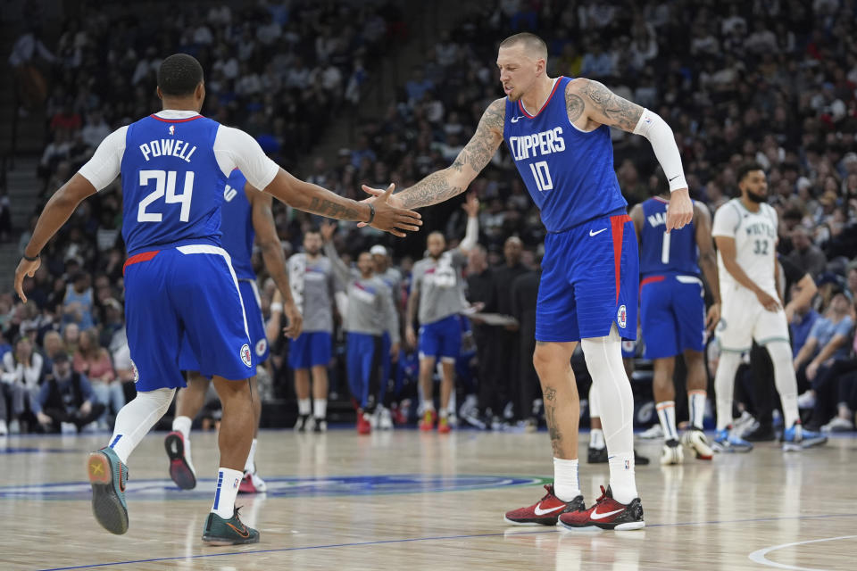 Los Angeles Clippers guard Norman Powell (24) high-fives center Daniel Theis (10) after making a 3-point basket during the second half of an NBA basketball game against the Minnesota Timberwolves, Sunday, March 3, 2024, in Minneapolis. (AP Photo/Abbie Parr)