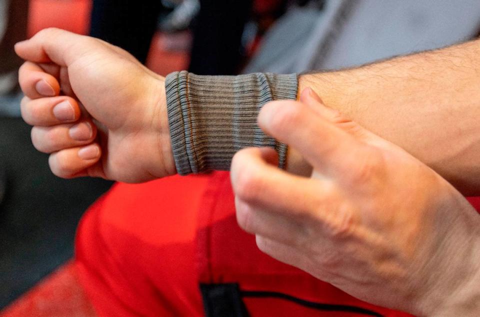 Carolina Hurricanes defenseman Dylan Coghlan (15) shows the Kevlar sleeve he wears to protect his wrist from a skate cut following practice on Thursday, May 2, 2024 at PNC Arena in Raleigh, N.C. Robert Willett/rwillett@newsobserver.com