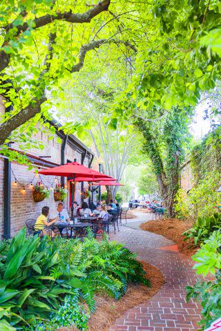 <p>Robbie Caponetto</p> Enjoy a tree-shaded meal in the pocket park between Jonah's Fish & Grits and Liam's.