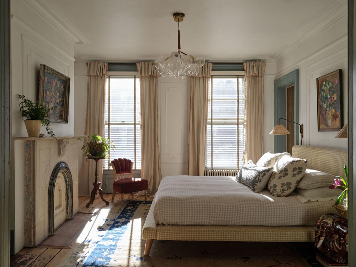 a bedroom with a fireplace and a bed