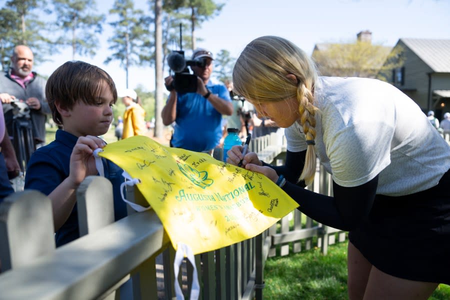 Ingrid Lindblad of Sweden signs autographs for a young patron after round one of the Augusta National Women’s Amateur at Champions Retreat Golf Club, Wednesday, April 3, 2024.
