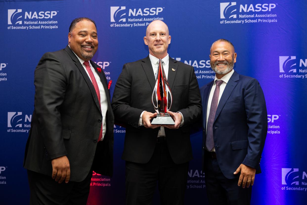 Andrew Farley (middle) accepts the award from the National Association of Secondary School Principals on Oct. 20 at a celebration in Washington, D.C.