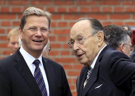 German Foreign Minister Guido Westerwelle (L) and former Foreign Minister Hans-Dietrich Genscher attend a ceremony marking 50th anniversary of building of Berlin Wall at memorial site in Bernauer Street in Berlin, in this file picture taken August 13, 2011. REUTERS/Thomas Peter/Files