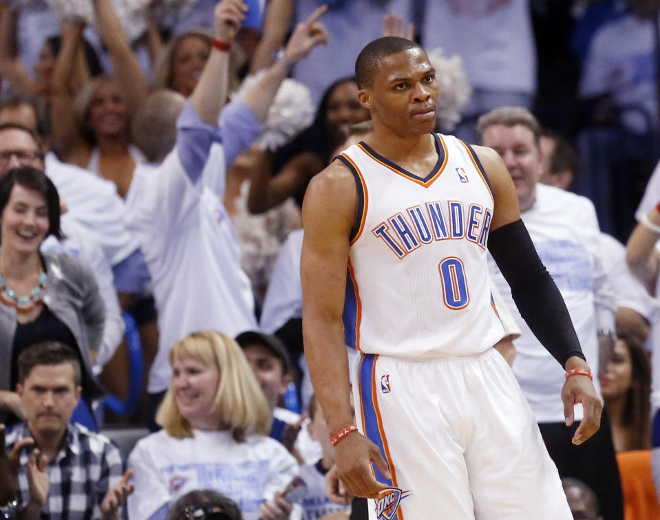 Fans cheer as Oklahoma City Thunder guard Russell Westbrook reacts after a dunk in the first quarter of Game 5 of an opening-round NBA basketball playoff series against the Memphis Grizzlies in Oklahoma City, Tuesday, April 29, 2014. (AP Photo)