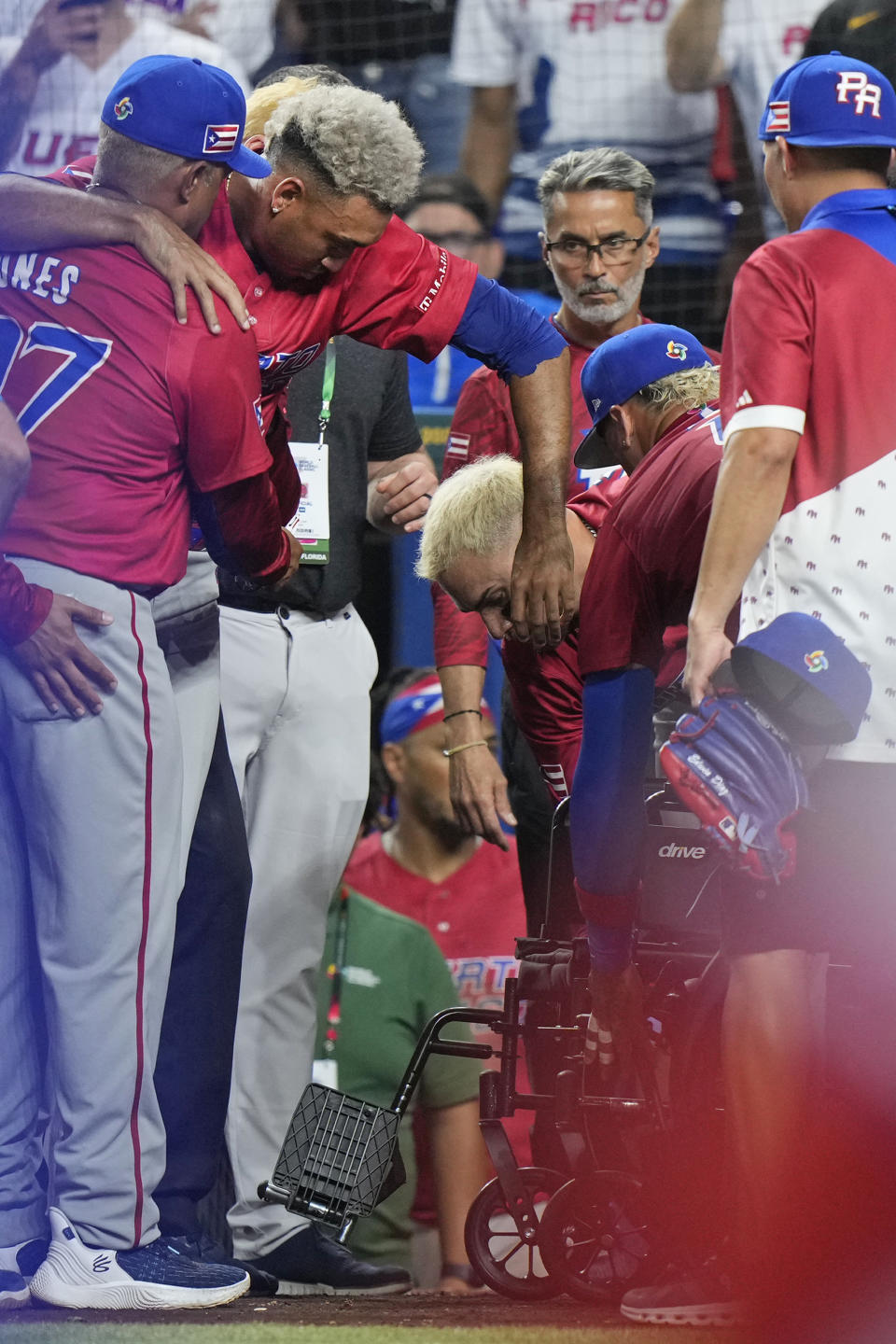 Puerto Rico pitcher Edwin Diaz is helped into a wheelchair after he appeared to injure himself during postgame celebration after Puerto Rico beat the Dominican Republic 5-2 during a World Baseball Classic game, Wednesday, March 15, 2023, in Miami. (AP Photo/Wilfredo Lee)