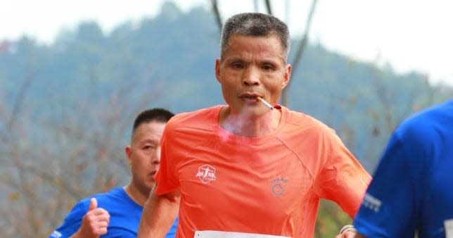 Smoking "Uncle Chen" as he runs the Xin’anjiang Marathon