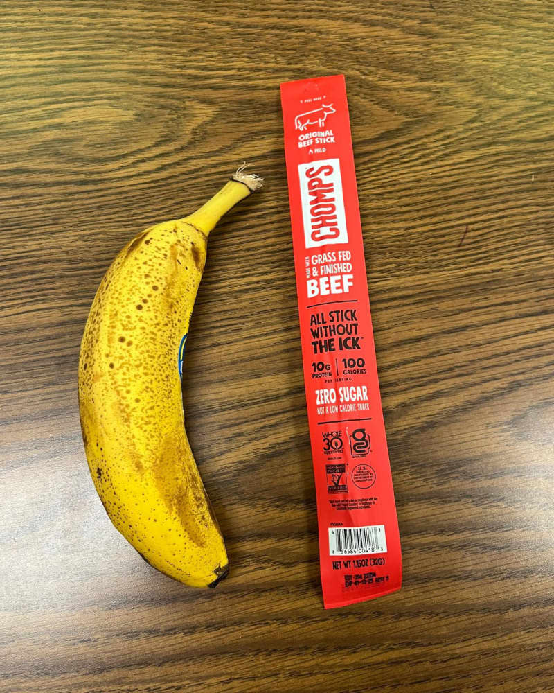 banana and stick of jerky on table